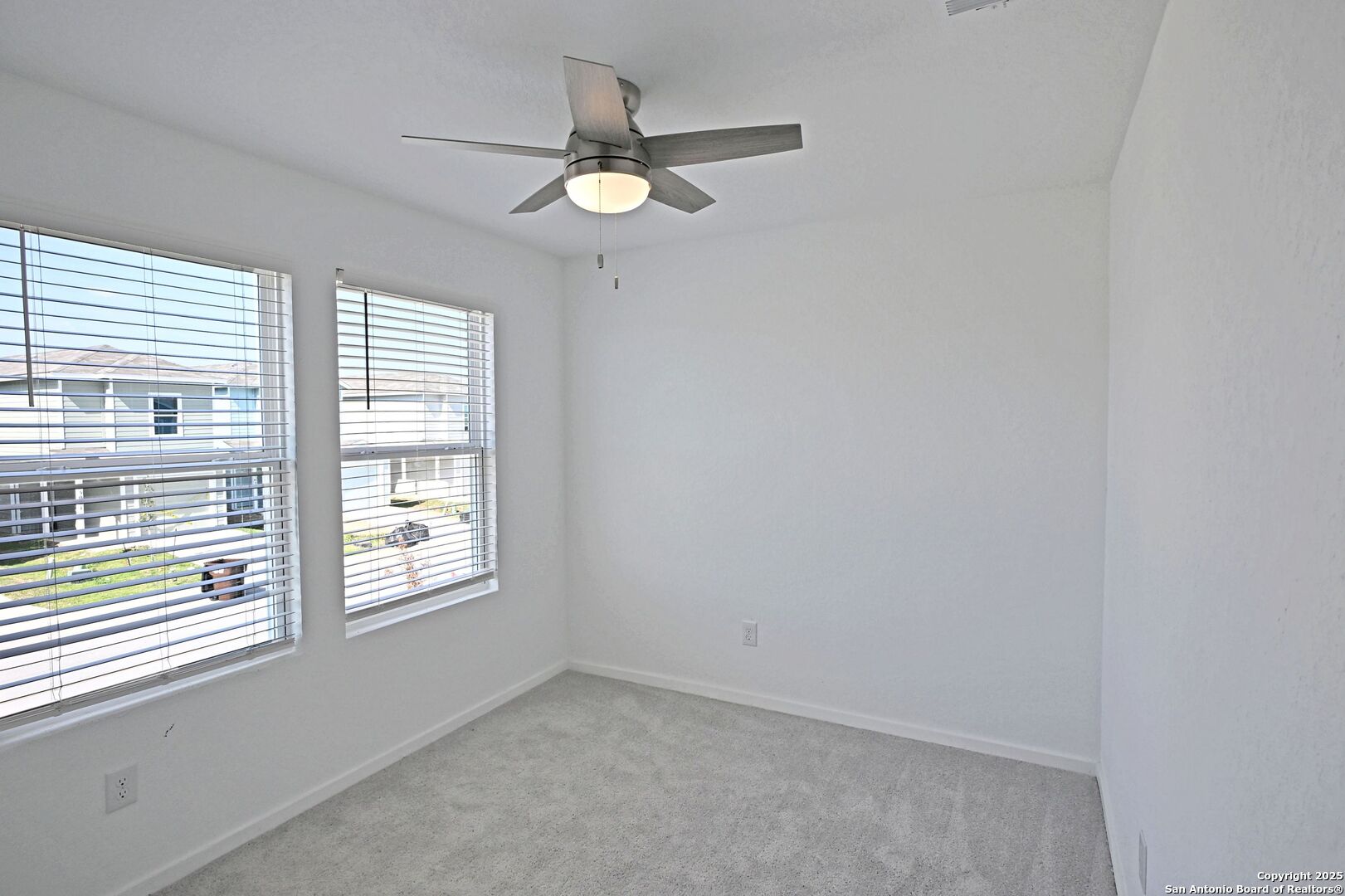5014 Winecup Cove Converse, TX 78109 - Photo 23 of 25 an empty room with windows and fan