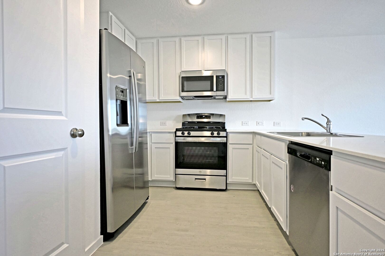 5014 Winecup Cove Converse, TX 78109 - Photo 5 of 25 a kitchen with stainless steel appliances a refrigerator sink and stove