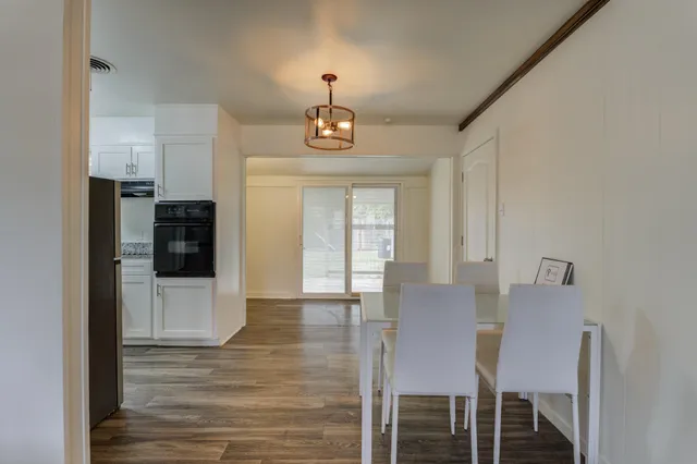 a view of a dining room with furniture and wooden floor