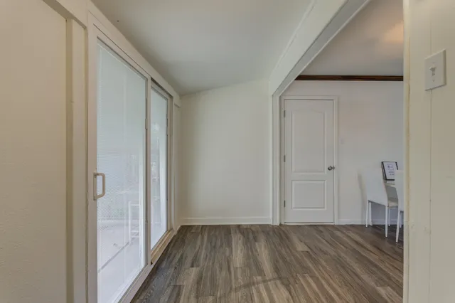 a view of a hallway with wooden floor