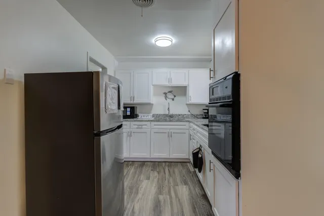 a kitchen with a refrigerator and a sink