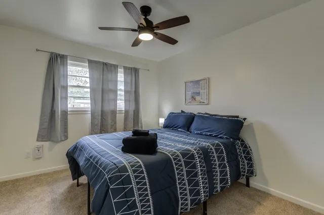 a bedroom with a large bed and a window