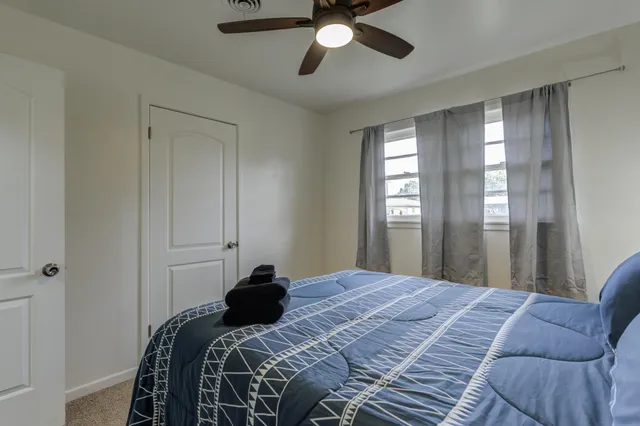 a bedroom with a bed and window
