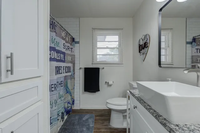 a bathroom with a toilet a sink and a bathtub