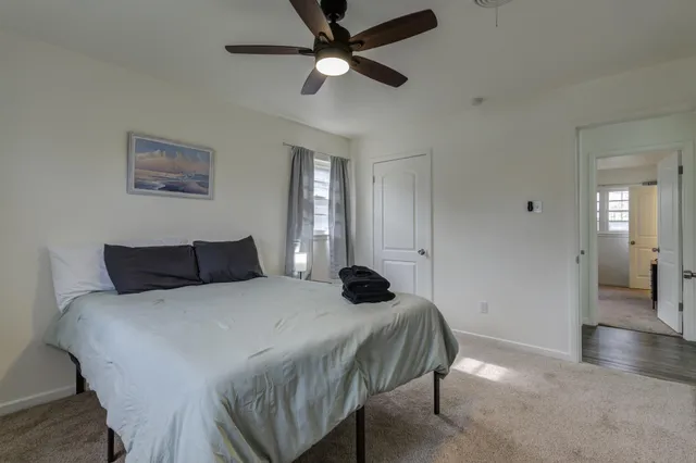 a bedroom with a bed and a chandelier