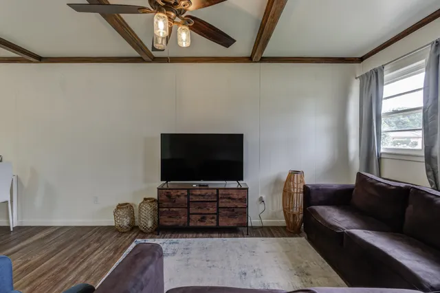 a living room with furniture and a flat screen tv