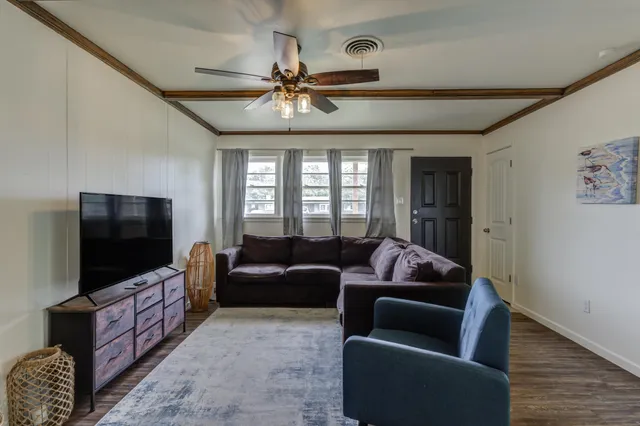 a living room with furniture and a flat screen tv