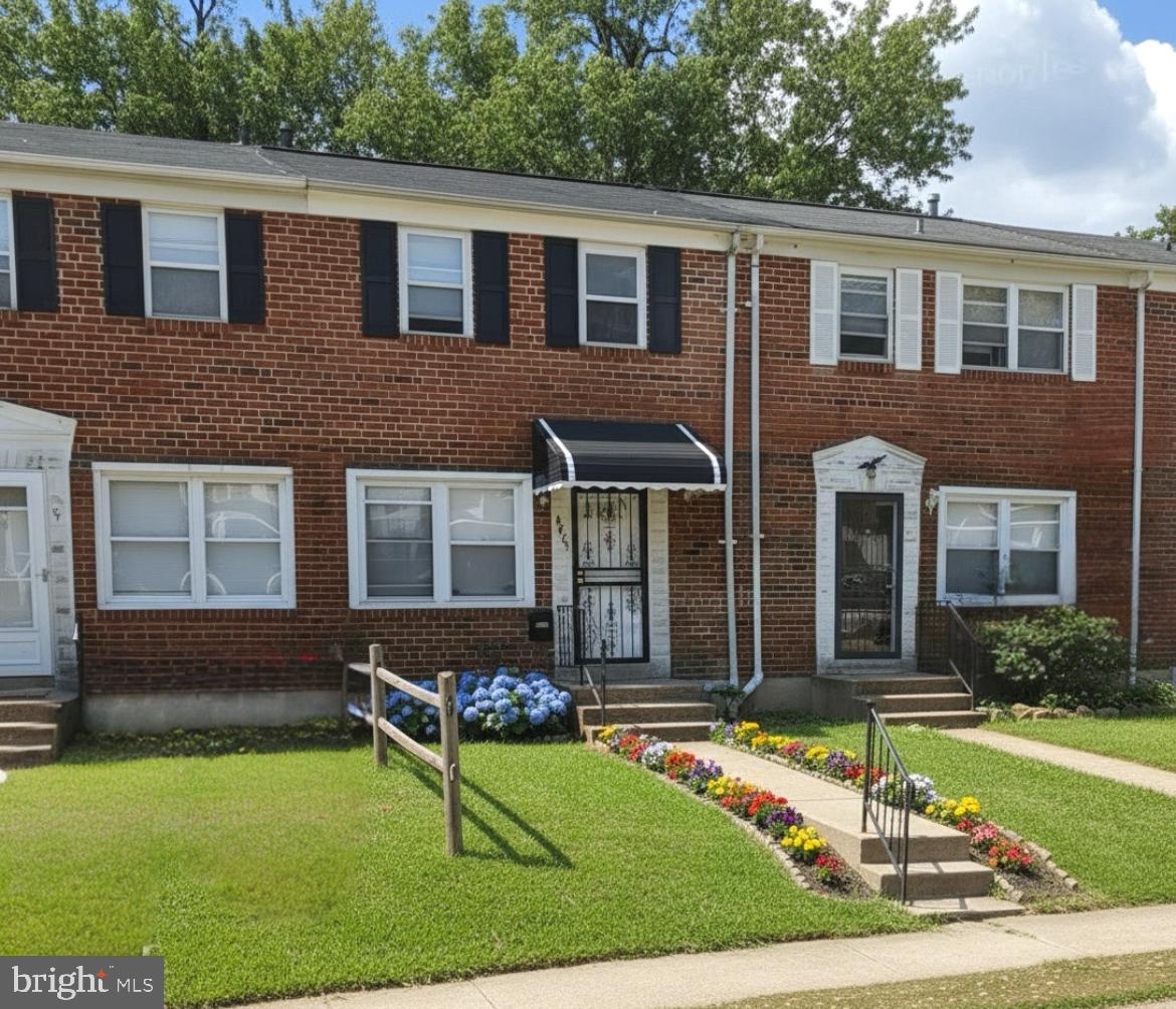 4865 Melbourne Road Baltimore, MD 21229 - Photo 1 of 19 a front view of a house with garden
