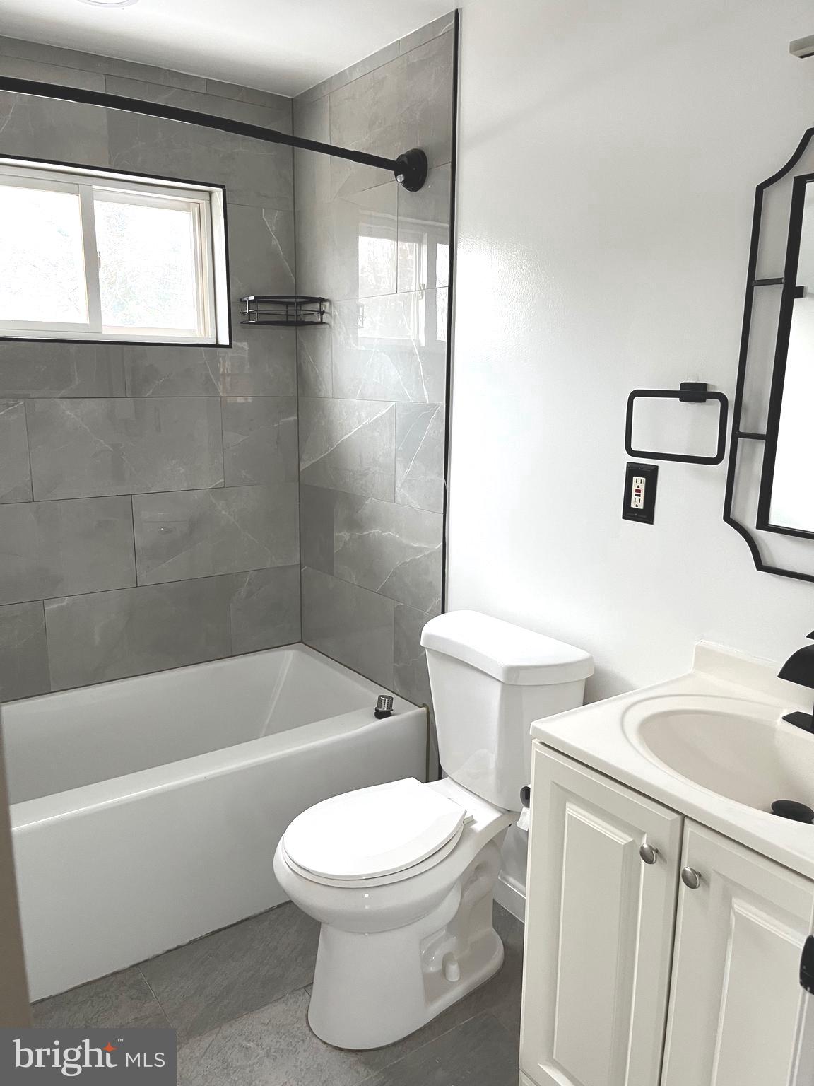 4865 Melbourne Road Baltimore, MD 21229 - Photo 11 of 19 a white toilet sitting next to a bath tub