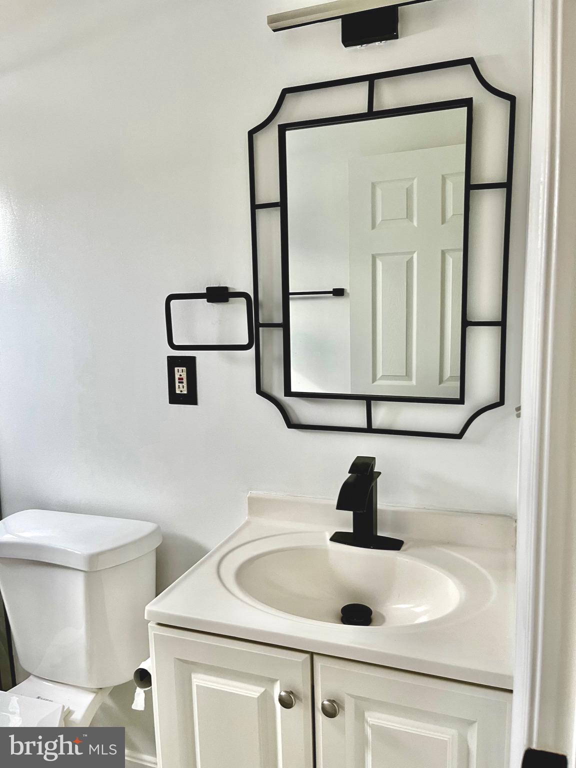4865 Melbourne Road Baltimore, MD 21229 - Photo 12 of 19 a bathroom with a sink and a mirror