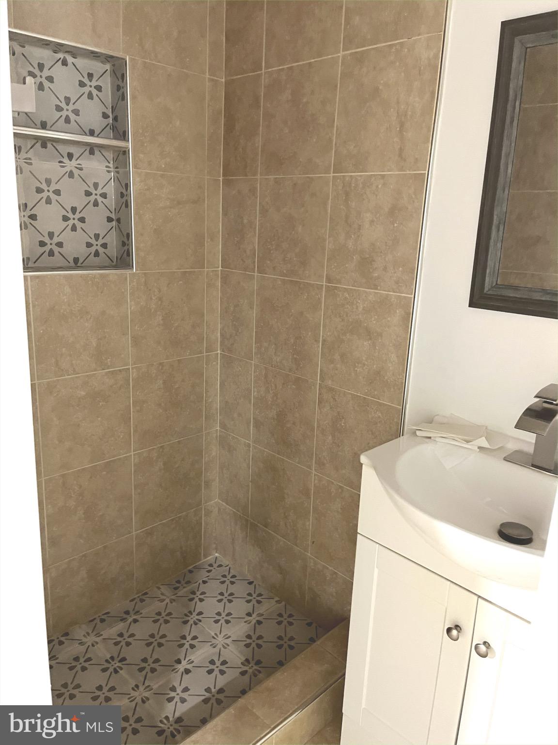 4865 Melbourne Road Baltimore, MD 21229 - Photo 16 of 19 a bathroom with a sink a toilet and shower