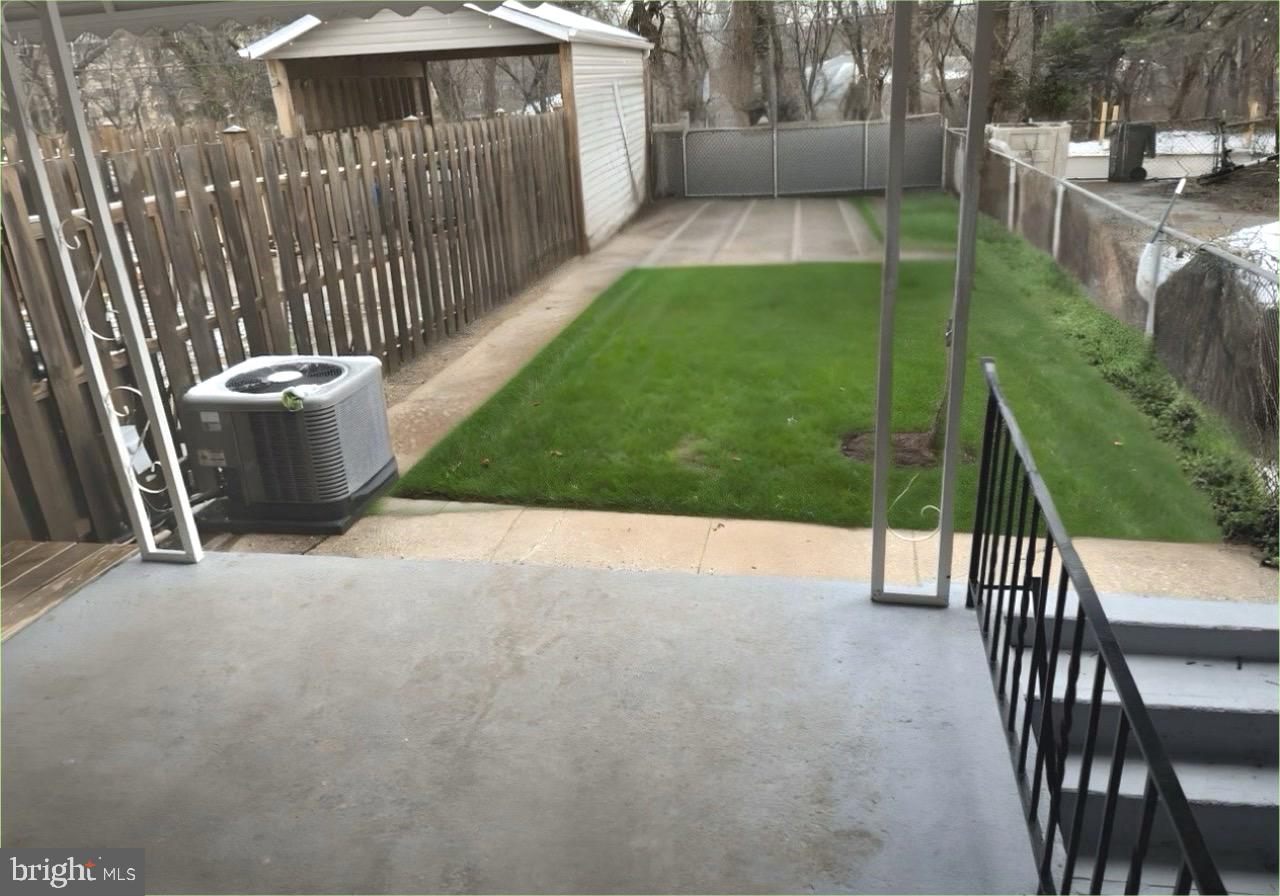 4865 Melbourne Road Baltimore, MD 21229 - Photo 19 of 19 a view of a patio with a table and chairs