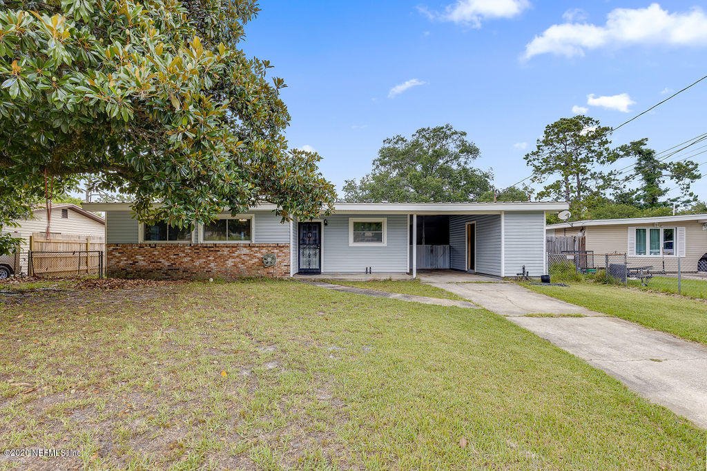 10453 Agave Road Jacksonville, FL 32246 - Photo 1 of 23 a front view of a house with a garden