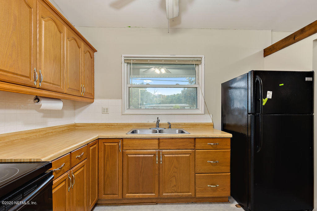 10453 Agave Road Jacksonville, FL 32246 - Photo 11 of 23 a kitchen with a sink and cabinets