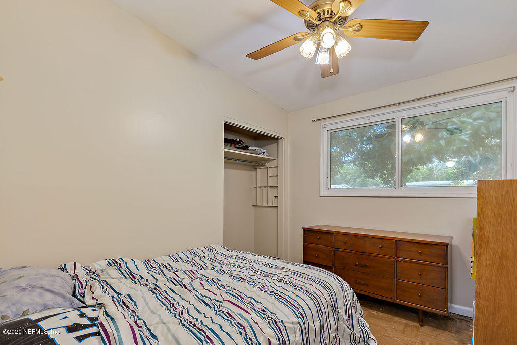10453 Agave Road Jacksonville, FL 32246 - Photo 15 of 23 a bedroom with a bed and a chandelier