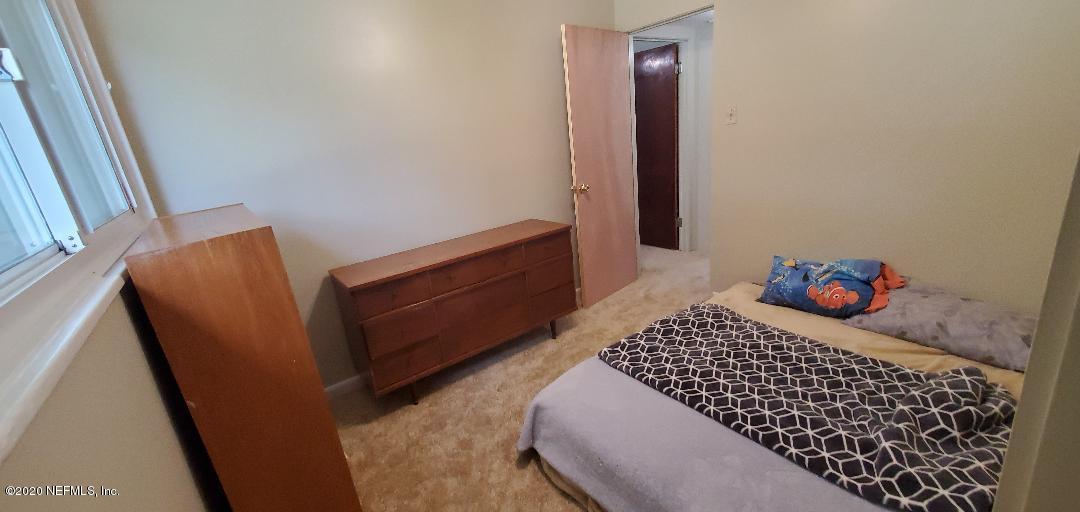 10453 Agave Road Jacksonville, FL 32246 - Photo 17 of 23 a bedroom with a bed and a dresser