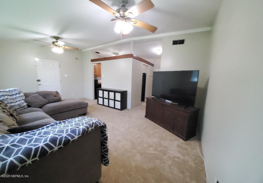 10453 Agave Road Jacksonville, FL 32246 - Photo 6 of 23 a living room with furniture and a flat screen tv