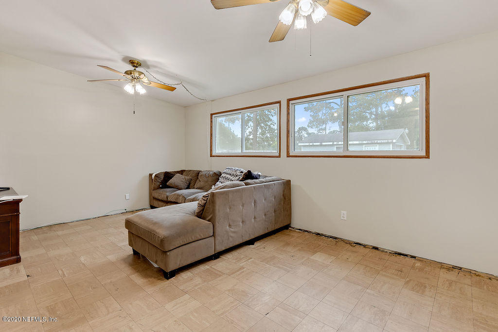 10453 Agave Road Jacksonville, FL 32246 - Photo 8 of 23 a living room with furniture and a large window
