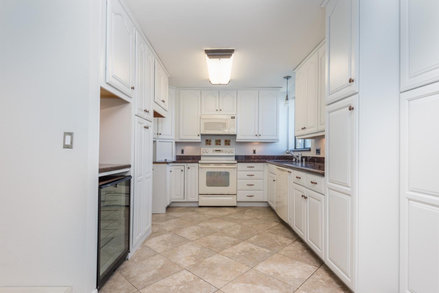 425 Anchor Road, Unit 317 San Mateo, CA 94404 - Photo 12 of 35 a kitchen with stainless steel appliances cabinets and a refrigerator