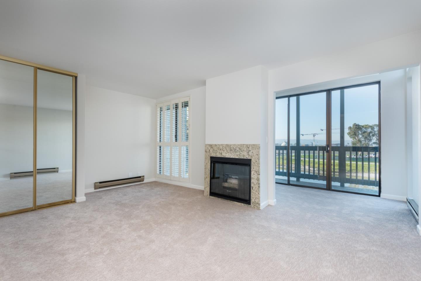 425 Anchor Road, Unit 317 San Mateo, CA 94404 - Photo 21 of 35 a view of an empty room with a fireplace and a window
