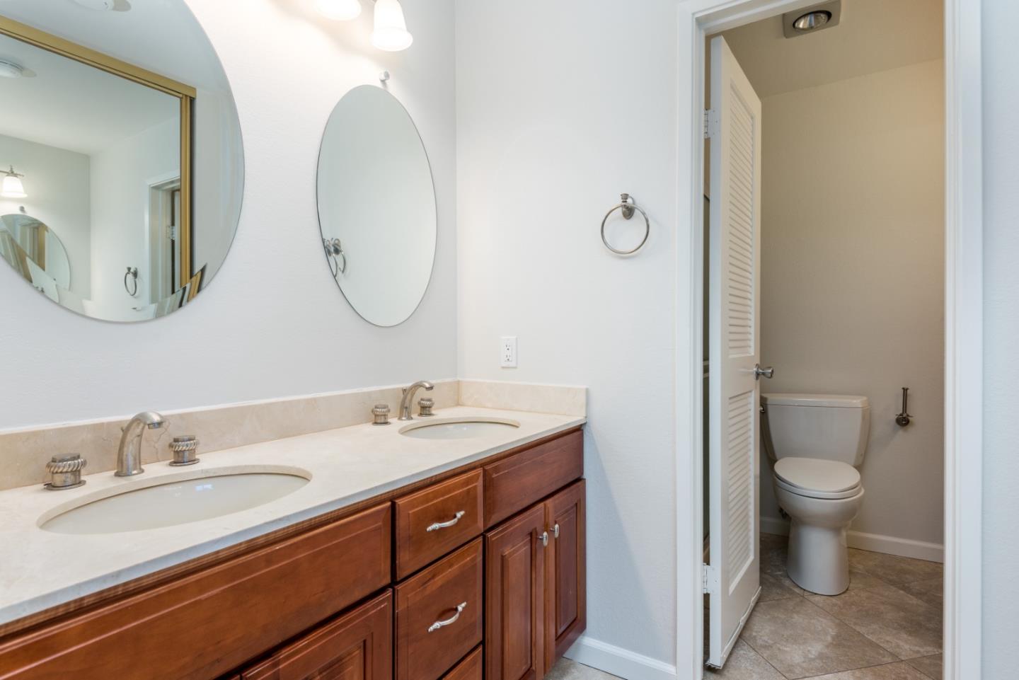 425 Anchor Road, Unit 317 San Mateo, CA 94404 - Photo 23 of 35 a bathroom with a toilet sink and mirror