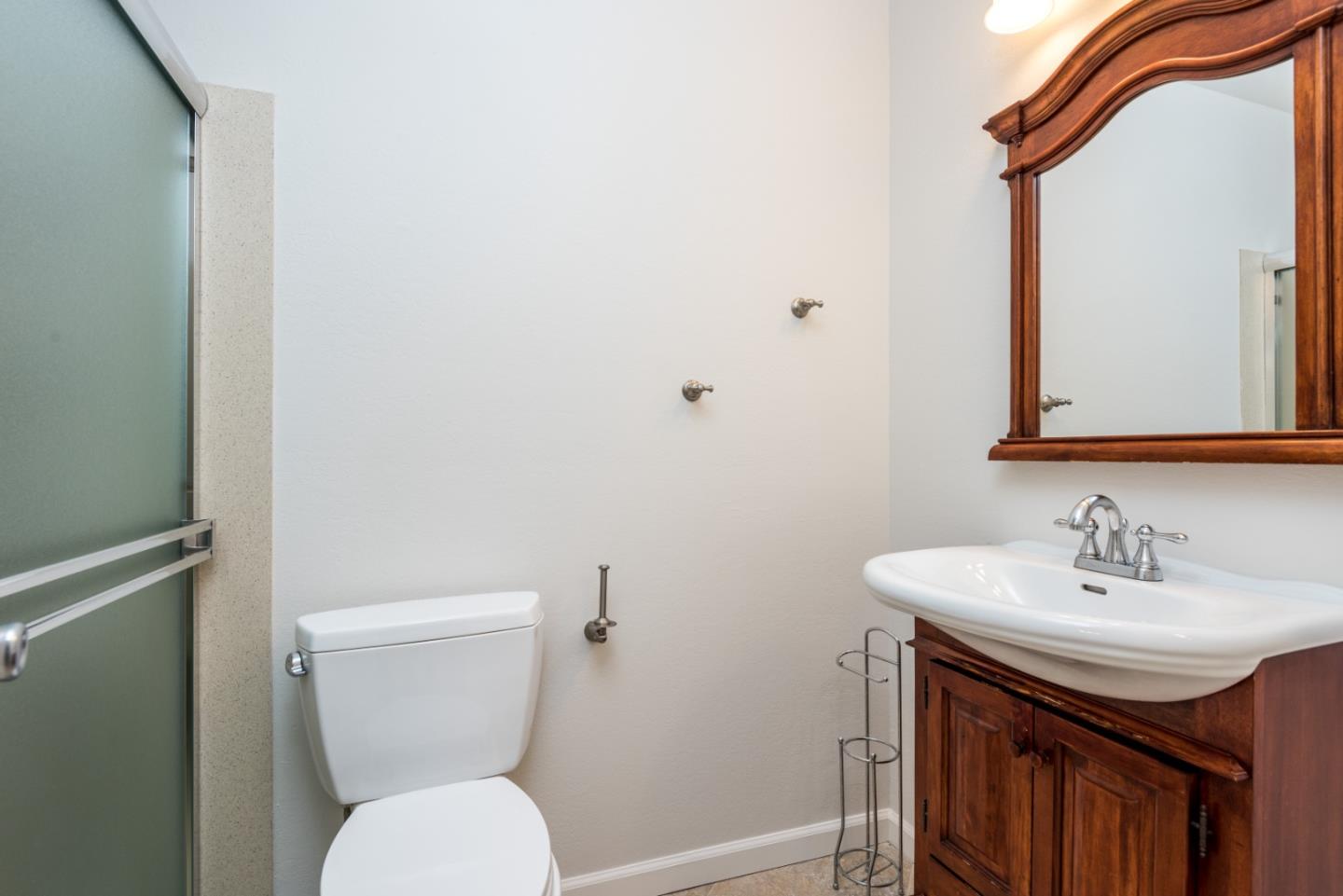 425 Anchor Road, Unit 317 San Mateo, CA 94404 - Photo 24 of 35 a bathroom with a toilet sink and mirror