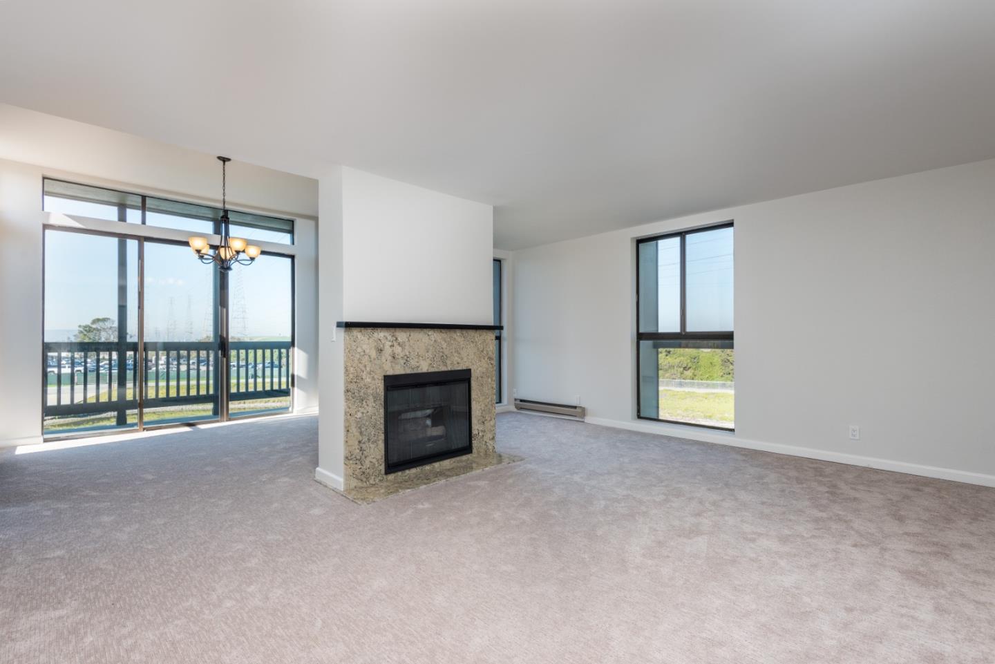 425 Anchor Road, Unit 317 San Mateo, CA 94404 - Photo 5 of 35 a view of an empty room with a fireplace and a window