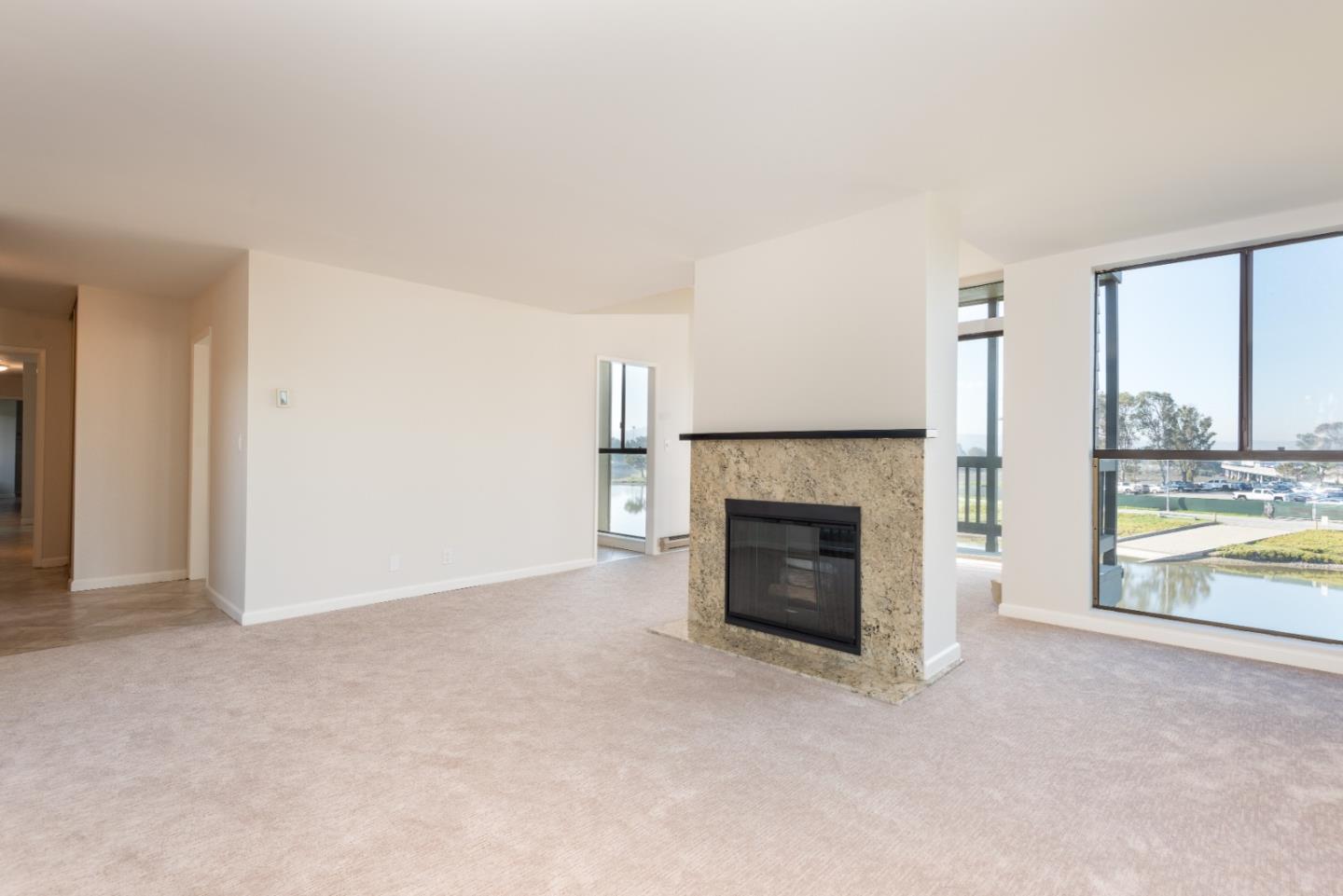 425 Anchor Road, Unit 317 San Mateo, CA 94404 - Photo 8 of 35 an empty room with fireplace and windows