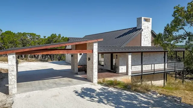 an aerial view of residential houses with outdoor space and trees