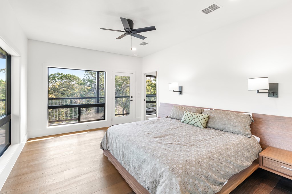199 Hermosa Road Southwest Hunt, TX 78024 - Photo 16 of 59 a bedroom with a large bed and a large window