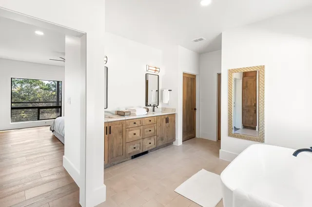 a bathroom with a granite countertop toilet sink and mirror
