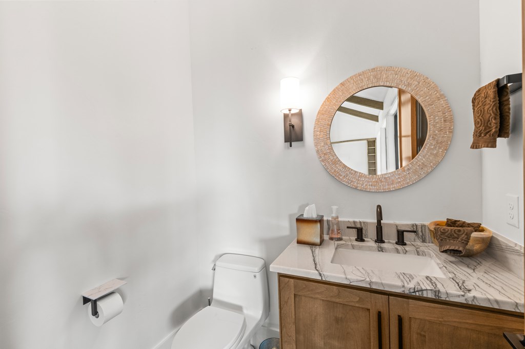 199 Hermosa Road Southwest Hunt, TX 78024 - Photo 21 of 59 a bathroom with a granite countertop toilet sink and mirror