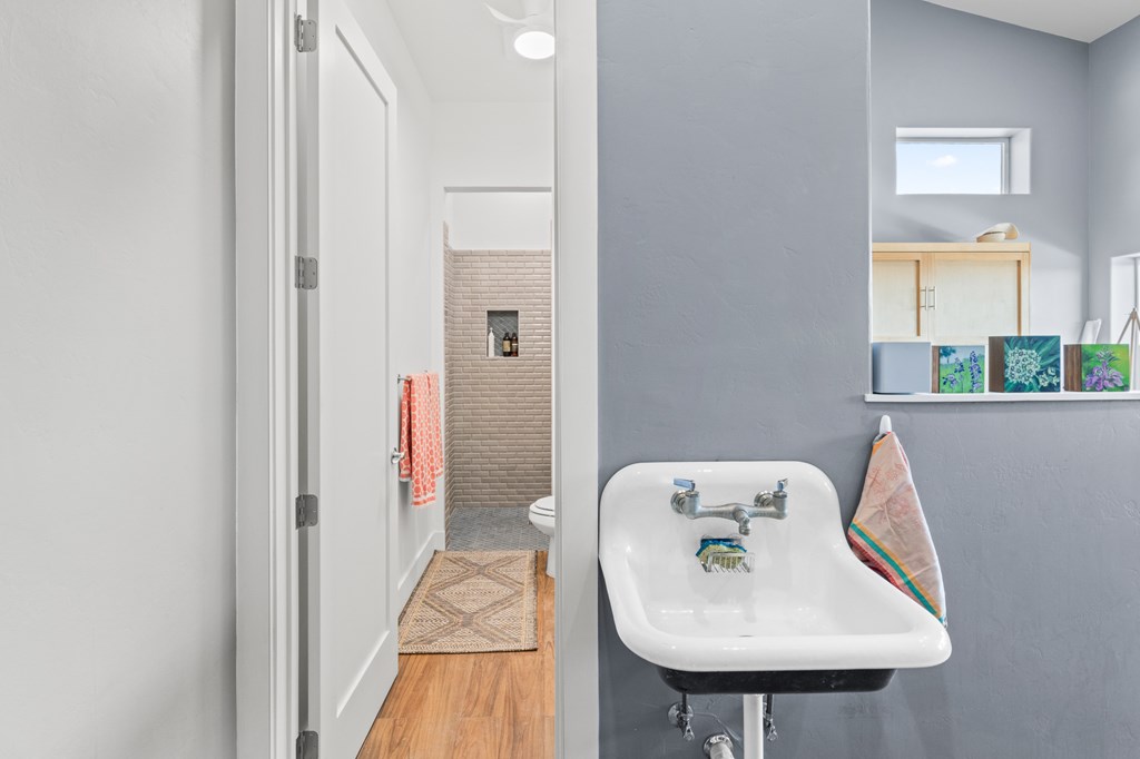 199 Hermosa Road Southwest Hunt, TX 78024 - Photo 37 of 59 a bathroom with a sink a mirror and a toilet