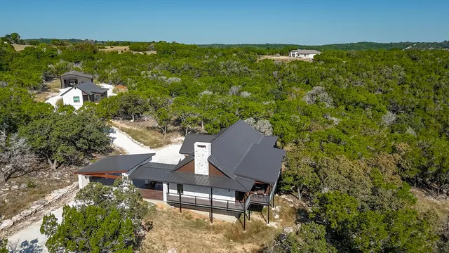 an aerial view of a house with a yard