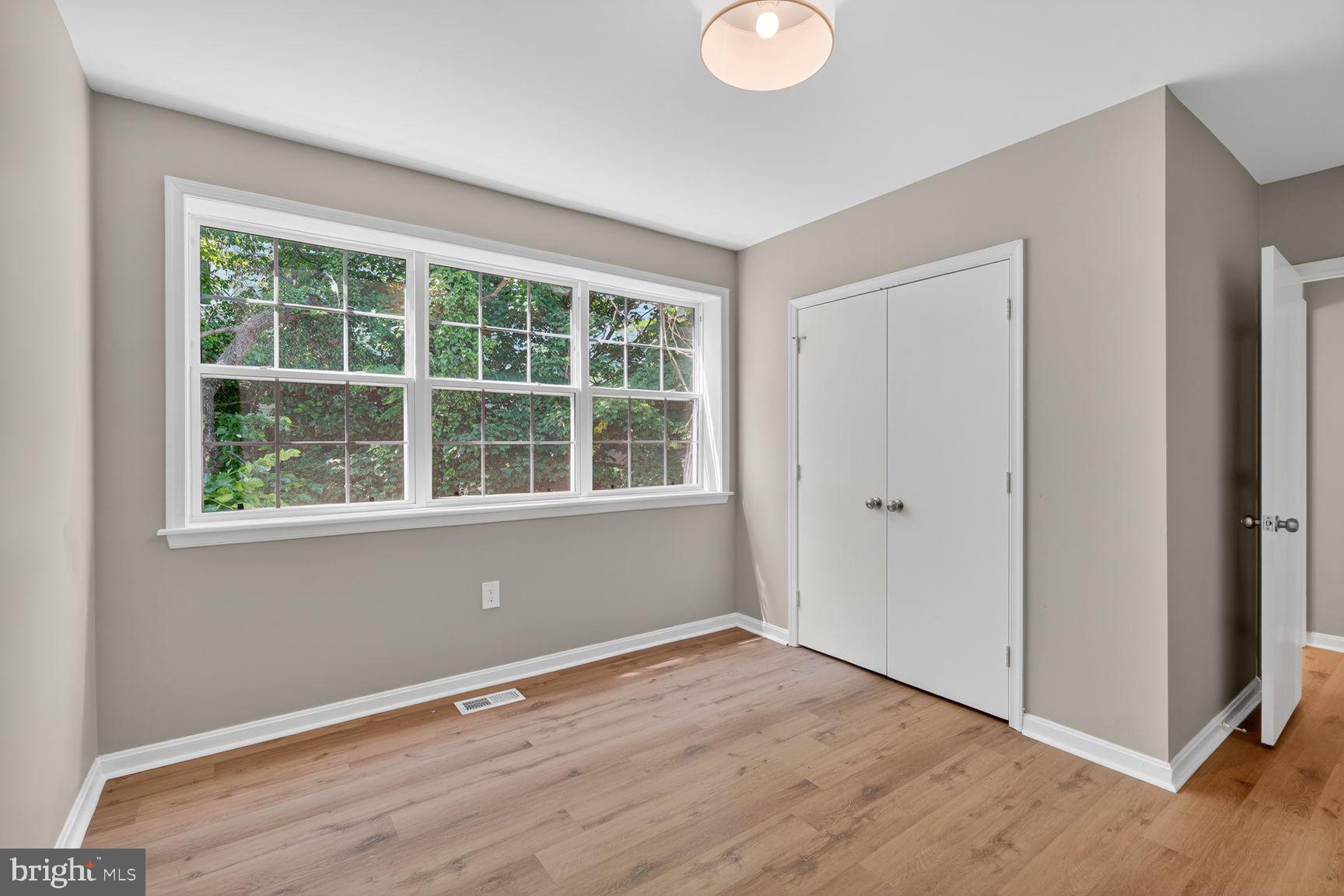 1008 Rittenhouse Street Northwest, Unit 15 Washington, DC 20011 - Photo 19 of 39 a view of an empty room with wooden floor and windows