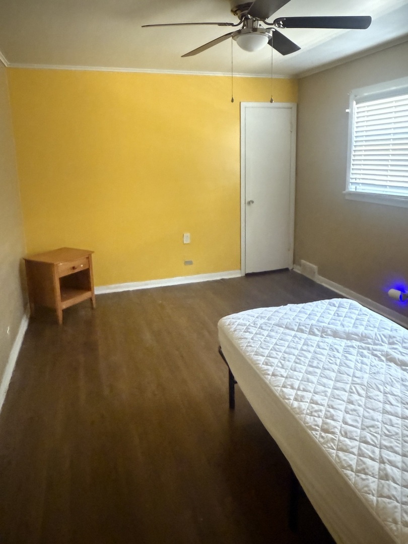 10553 South Calumet Avenue Chicago, IL 60628 - Photo 13 of 21 a view of a room with a ceiling fan