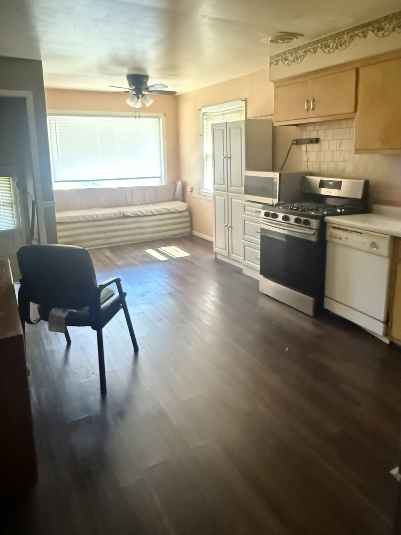 10553 South Calumet Avenue Chicago, IL 60628 - Photo 17 of 21 a kitchen with stainless steel appliances kitchen island granite countertop a stove a sink and a microwave