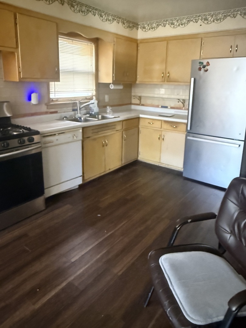 10553 South Calumet Avenue Chicago, IL 60628 - Photo 21 of 21 a kitchen with a sink appliances and cabinets