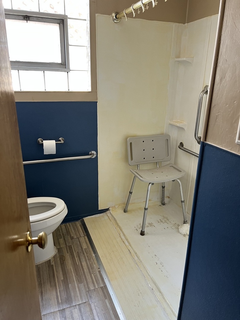 10553 South Calumet Avenue Chicago, IL 60628 - Photo 4 of 21 a bathroom with a toilet a sink and a window