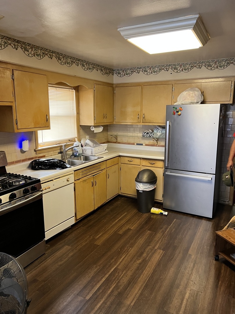 10553 South Calumet Avenue Chicago, IL 60628 - Photo 5 of 21 a kitchen with a sink appliances and cabinets
