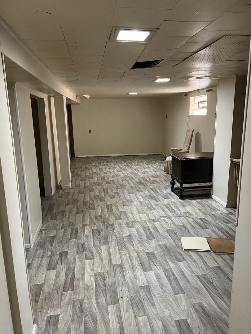 10553 South Calumet Avenue Chicago, IL 60628 - Photo 7 of 21 a room with wooden floor and furniture