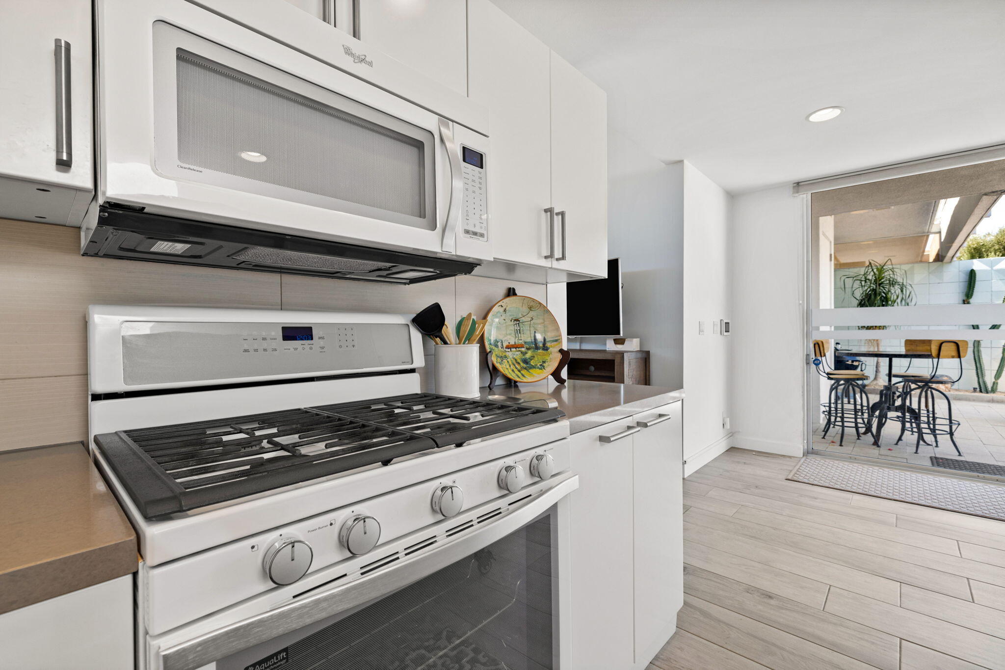 72857 El Paseo, Unit 502 Palm Desert, CA 92260 - Photo 12 of 48 a kitchen with a stove and white cabinets