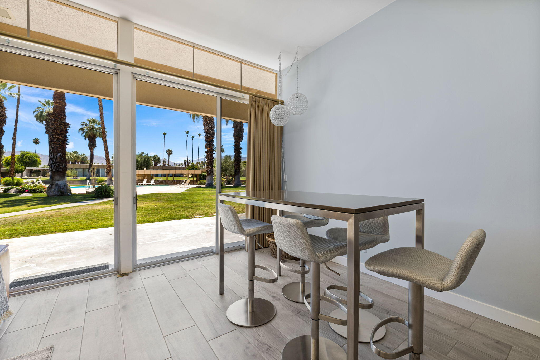 72857 El Paseo, Unit 502 Palm Desert, CA 92260 - Photo 18 of 48 a view of an outdoor dining space with a table and chairs
