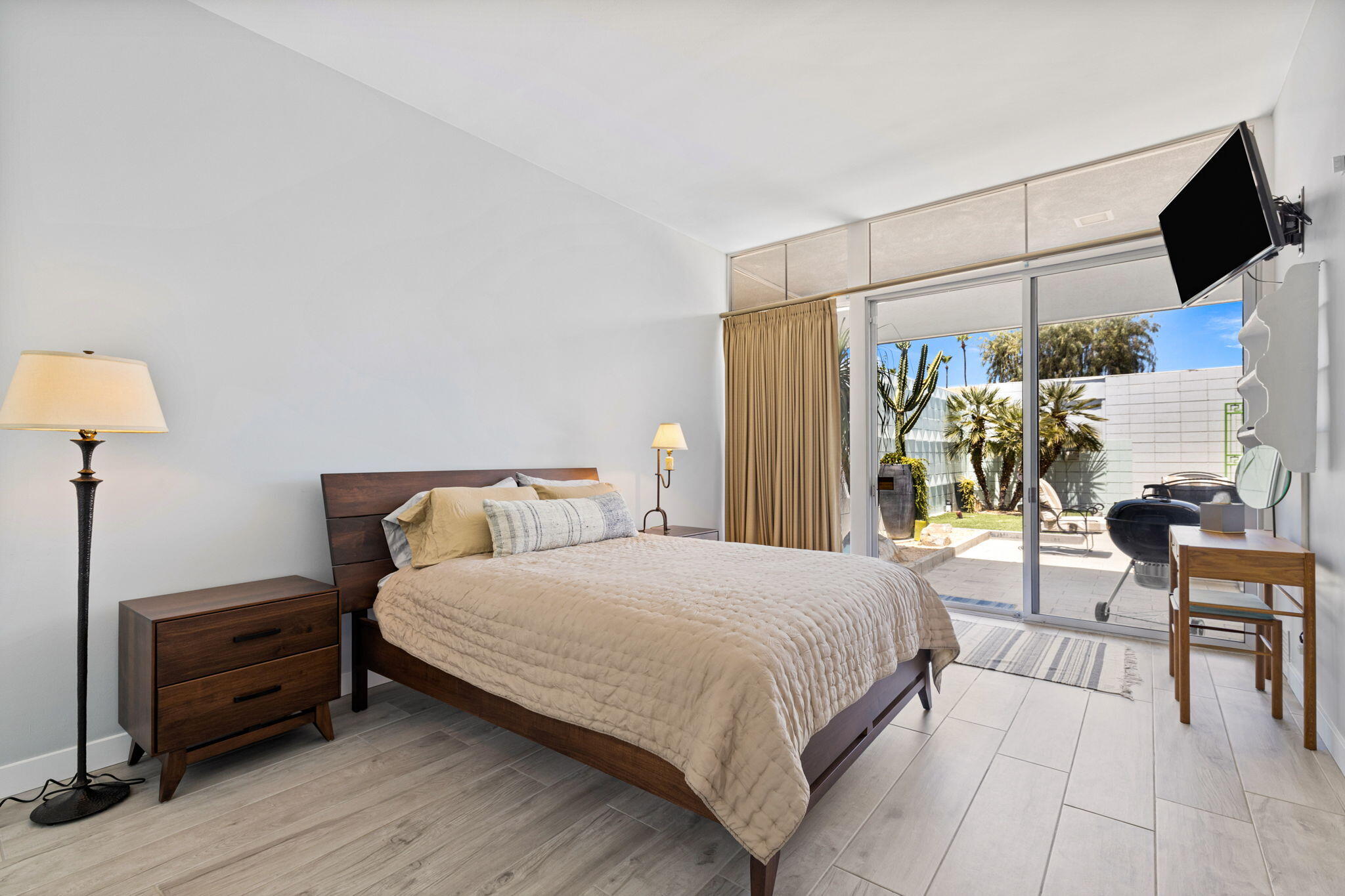 72857 El Paseo, Unit 502 Palm Desert, CA 92260 - Photo 19 of 48 a bedroom with a bed and a lamp on table