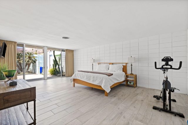 a bedroom with a bed and a table