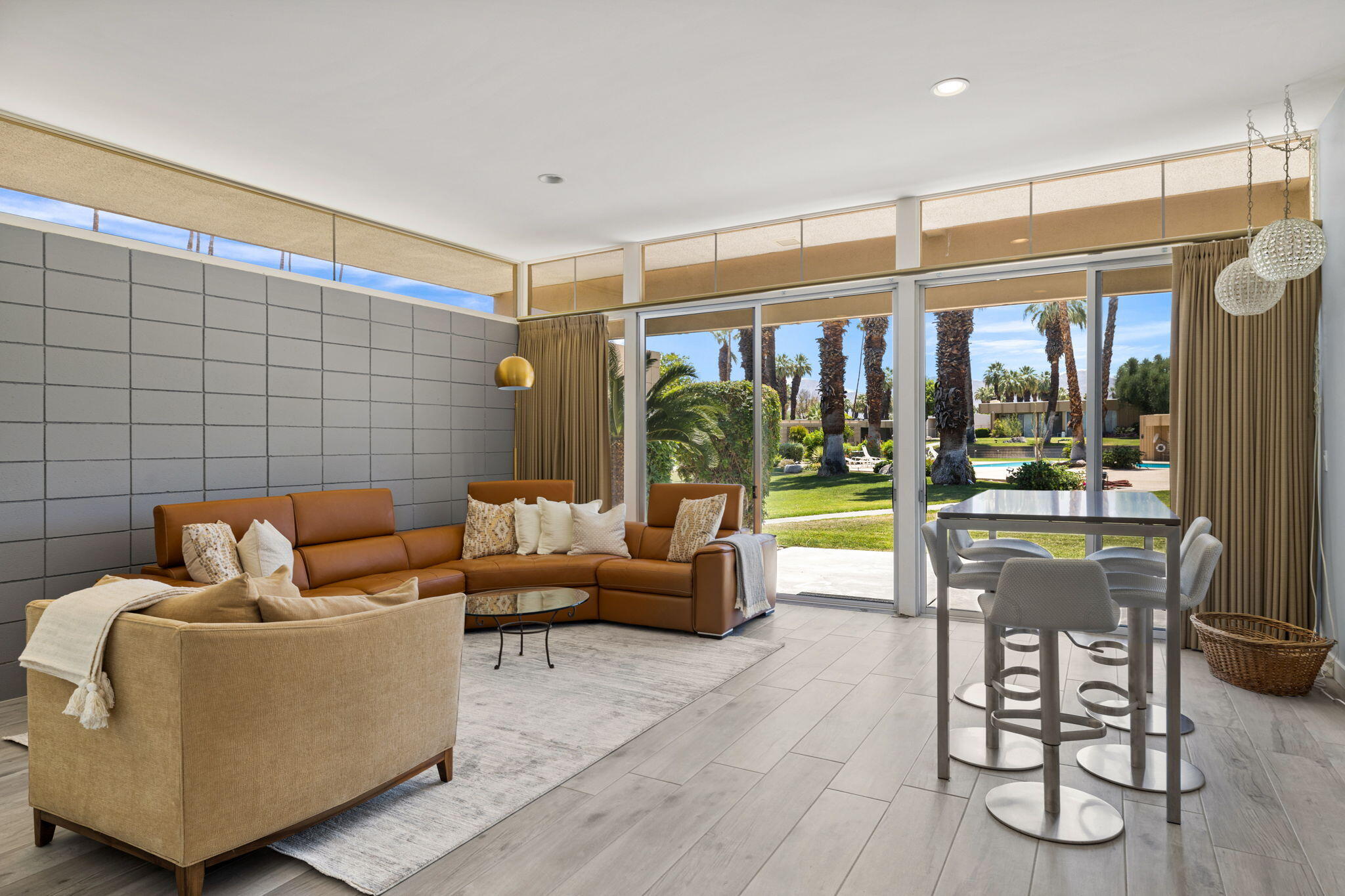 72857 El Paseo, Unit 502 Palm Desert, CA 92260 - Photo 3 of 48 a living room with furniture and a floor to ceiling window