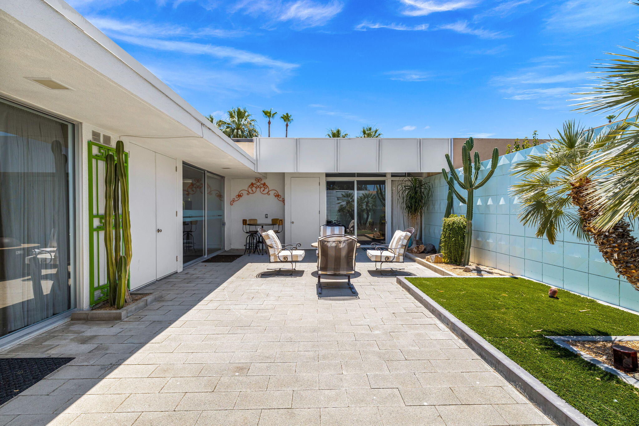 72857 El Paseo, Unit 502 Palm Desert, CA 92260 - Photo 38 of 48 a view of a patio with couches table and chairs and potted plants