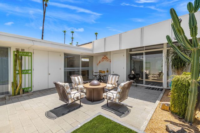 a building outdoor space with patio furniture and potted plants