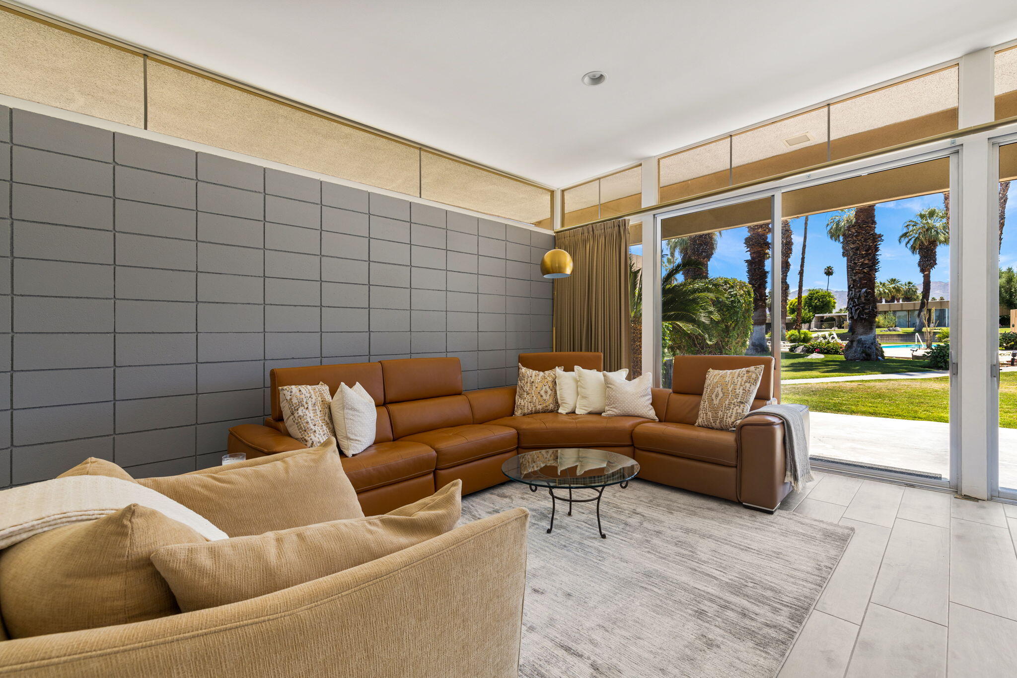 72857 El Paseo, Unit 502 Palm Desert, CA 92260 - Photo 6 of 48 a living room with furniture and a floor to ceiling window