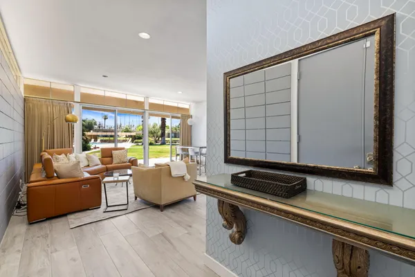 a living room with furniture and a floor to ceiling window